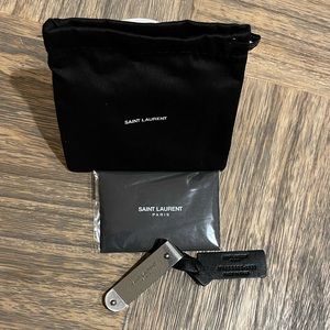 Yves Saint Laurent money clip in silver metal.